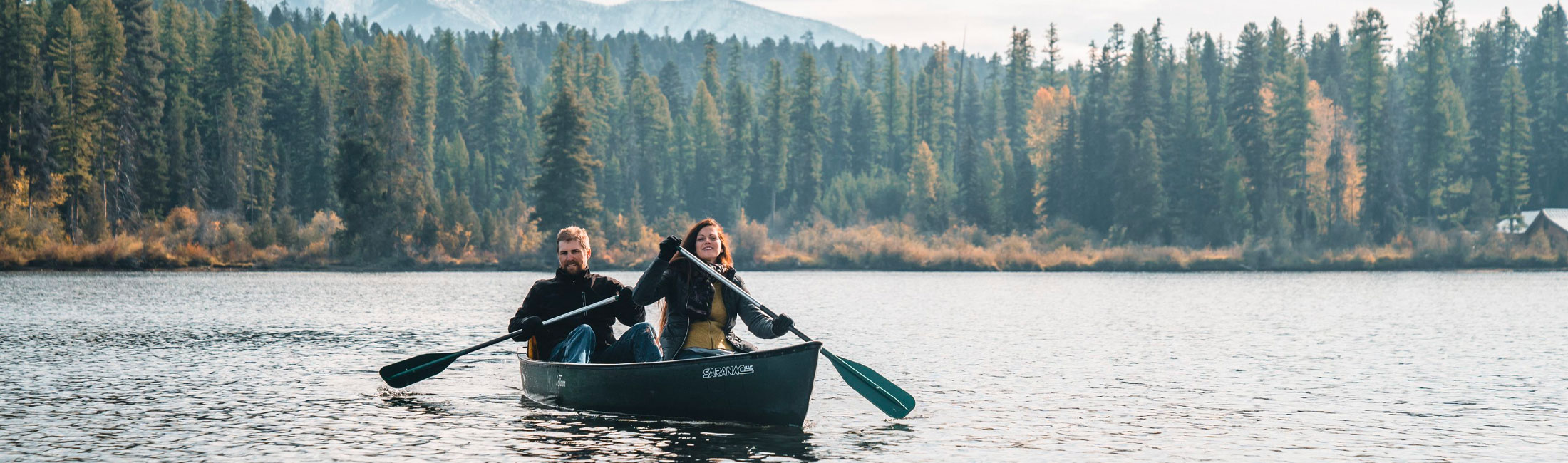 Paddline a canoe on a Western Montana lake in the fall.
